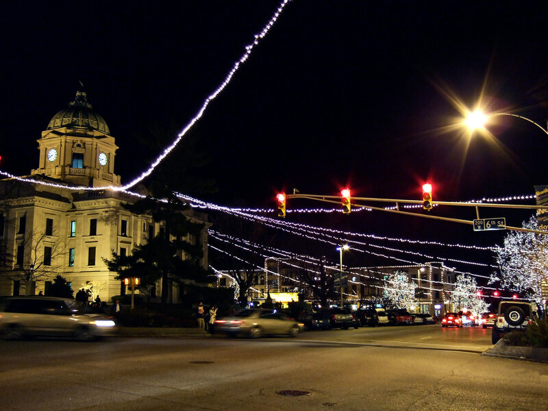 Nighttime city street with holiday lights