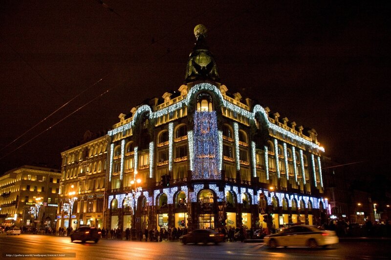 Nighttime city street with illuminated building