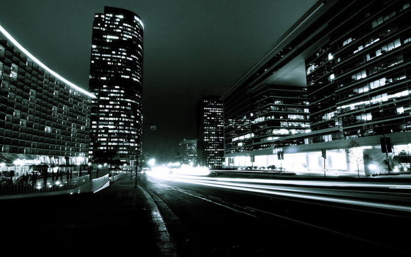 Nighttime city street with light trails