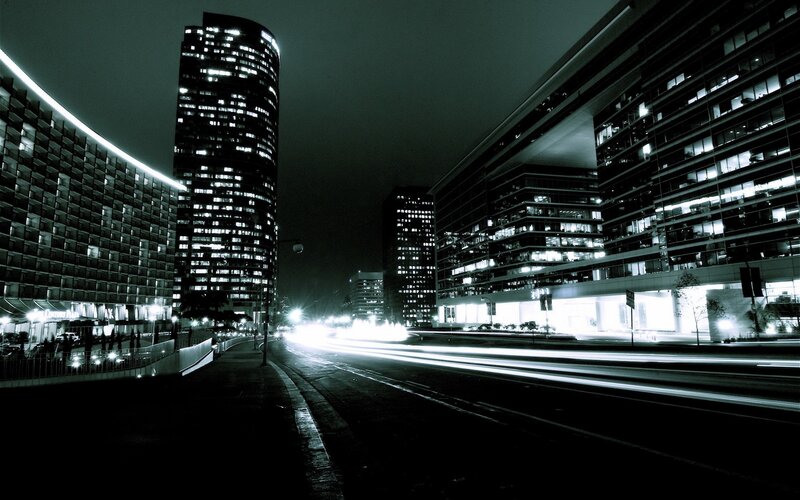 Nighttime city street with light trails