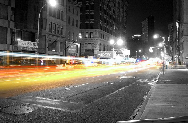 nighttime city street with light trails