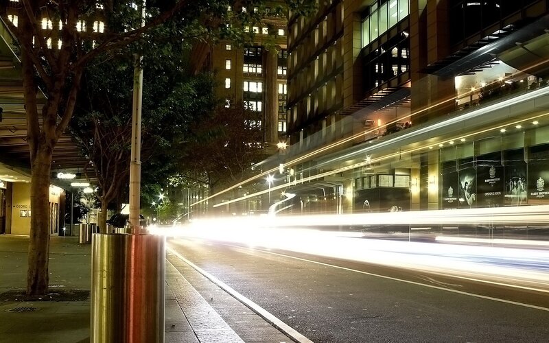 Nighttime city street with light trails