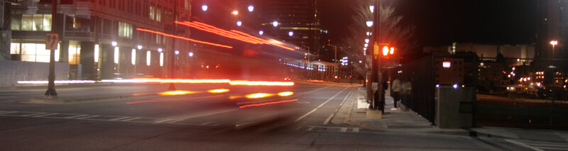 Nighttime city street with light trails