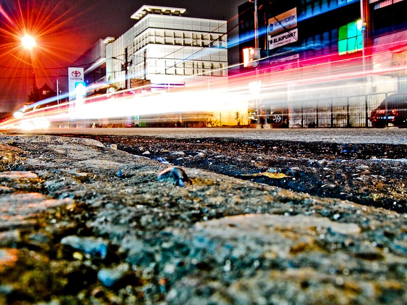 Nighttime city street with light trails