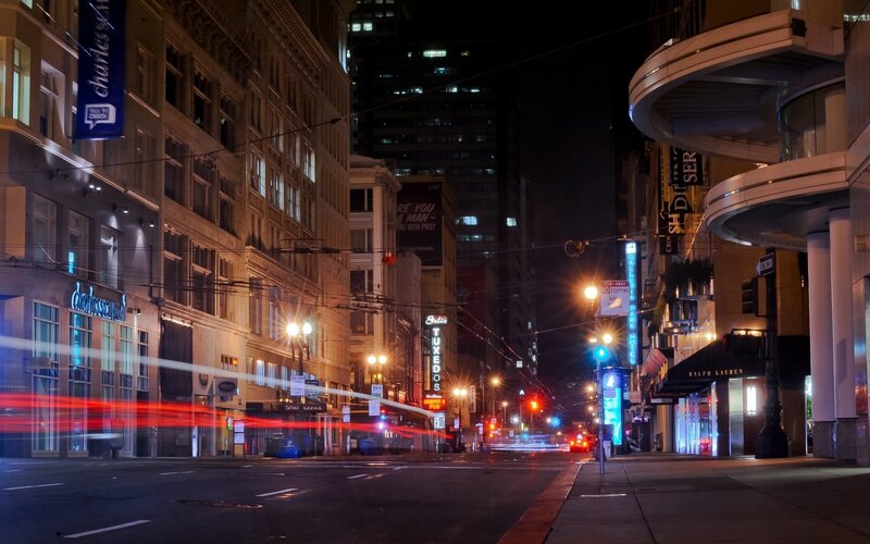 Nighttime city street with light trails