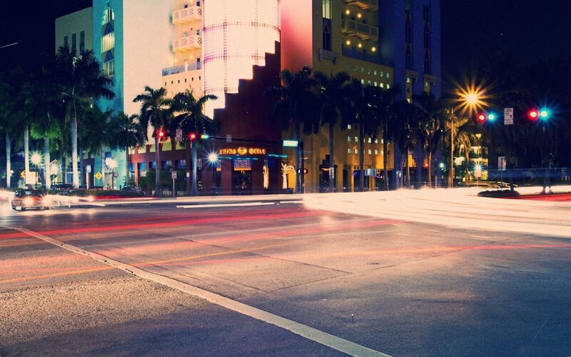 nighttime city street with light trails