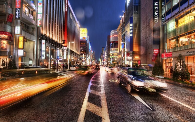 nighttime city street with light trails