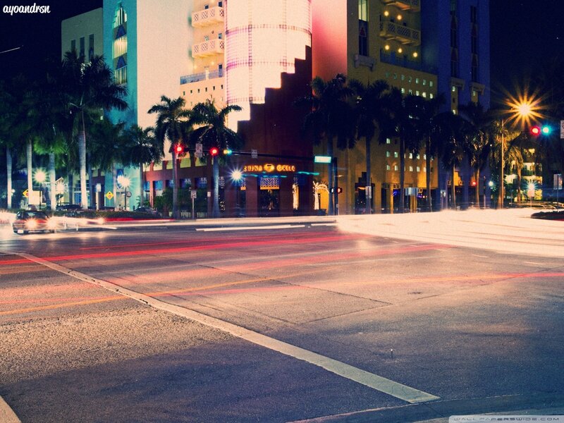 nighttime city street with light trails