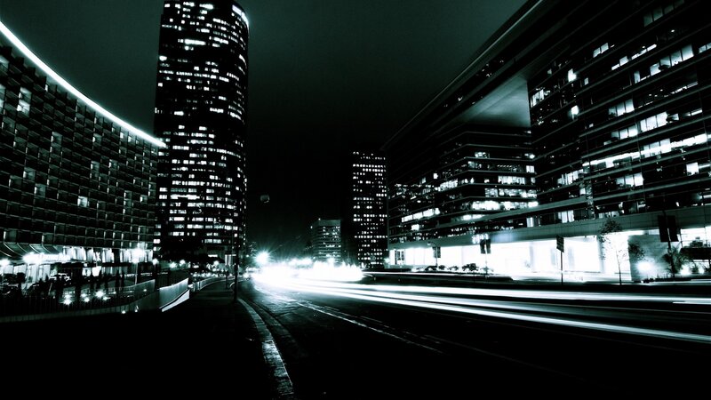 nighttime city street with light trails