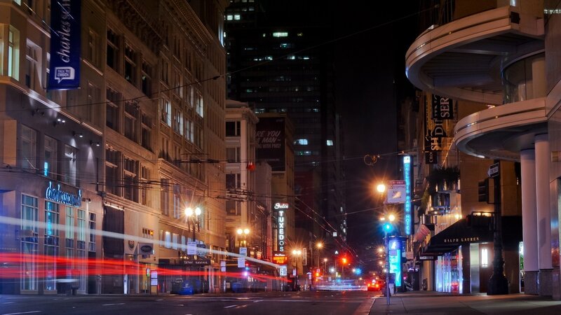 Nighttime city street with light trails