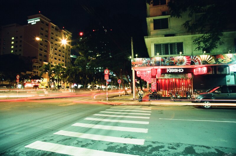 Nighttime city street with light trails