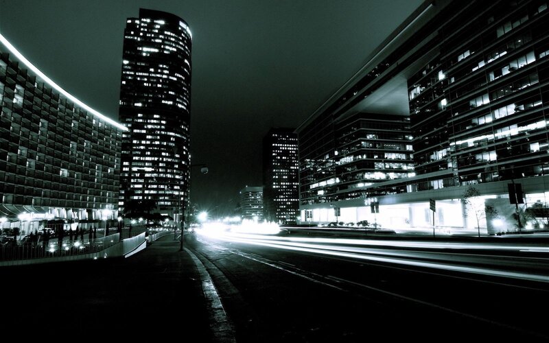 nighttime city street with light trails