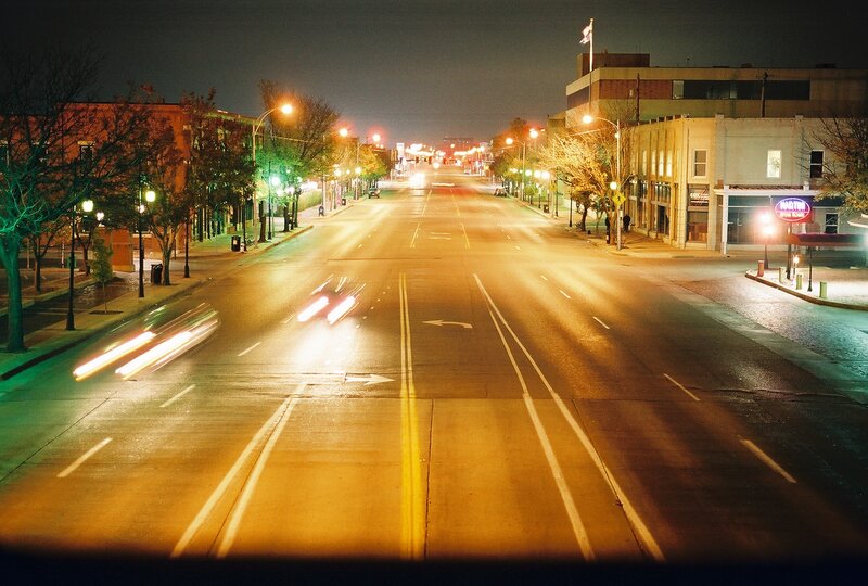 Nighttime city street with light trails