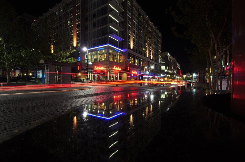 nighttime city street with light trails