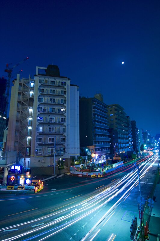 Nighttime city street with light trails