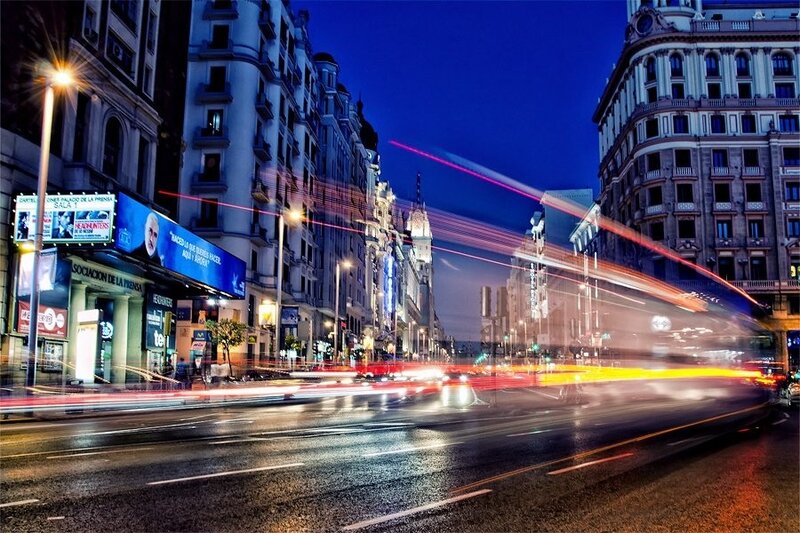 nighttime city street with light trails