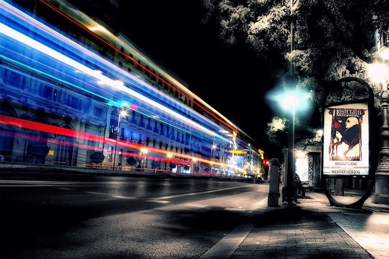 nighttime city street with light trails
