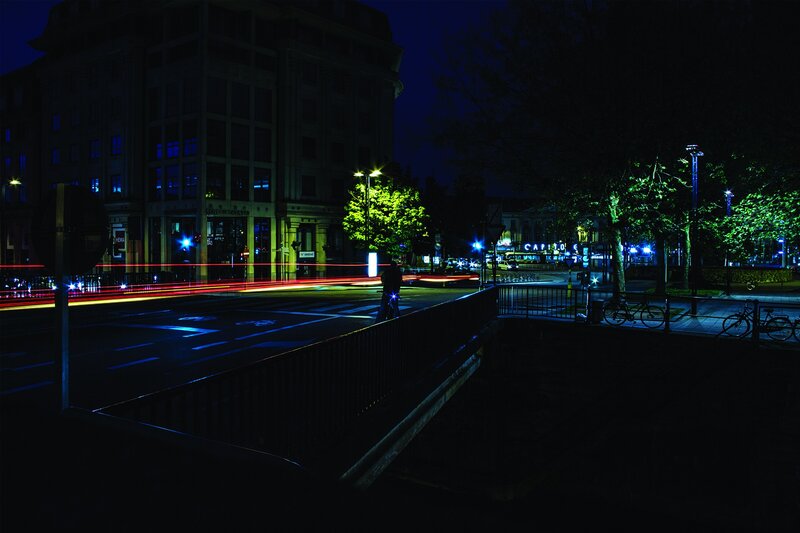 Nighttime city street with light trails