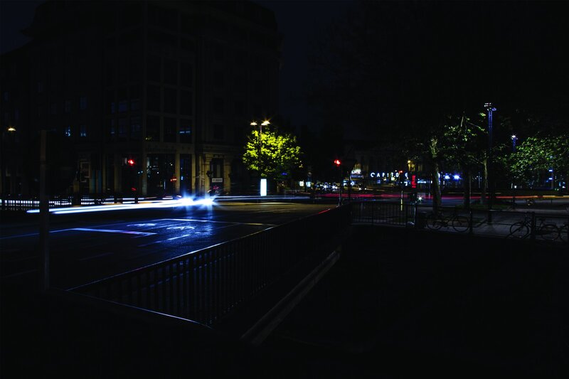 Nighttime city street with light trails