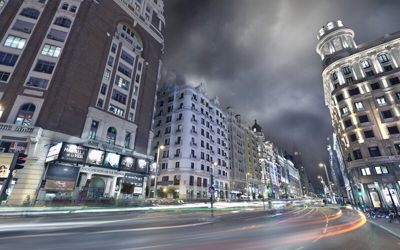 Nighttime city street with light trails