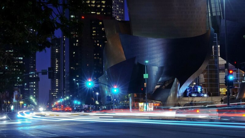 nighttime city street with modern architecture