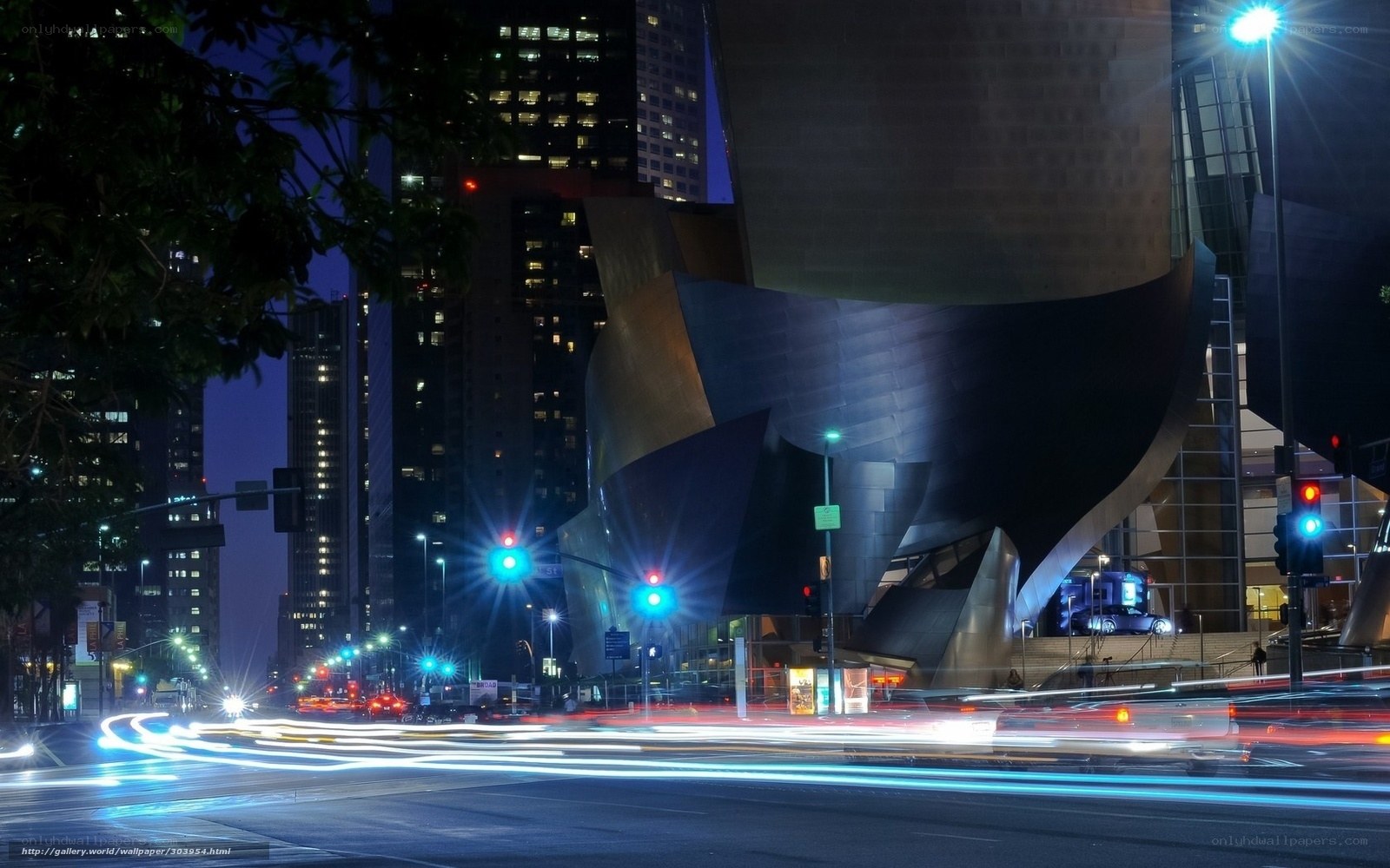Nighttime city street with modern building