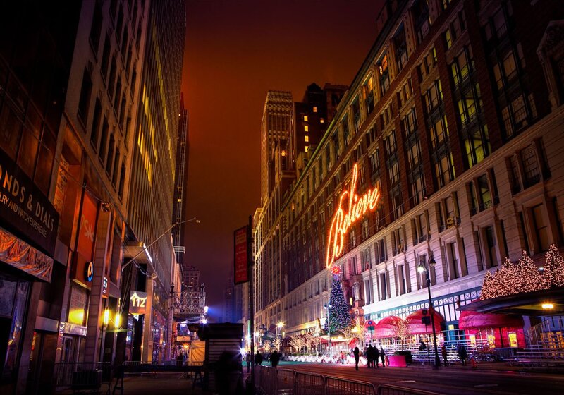 Nighttime city street with neon sign