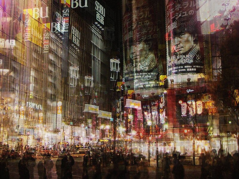 nighttime city street with neon signs