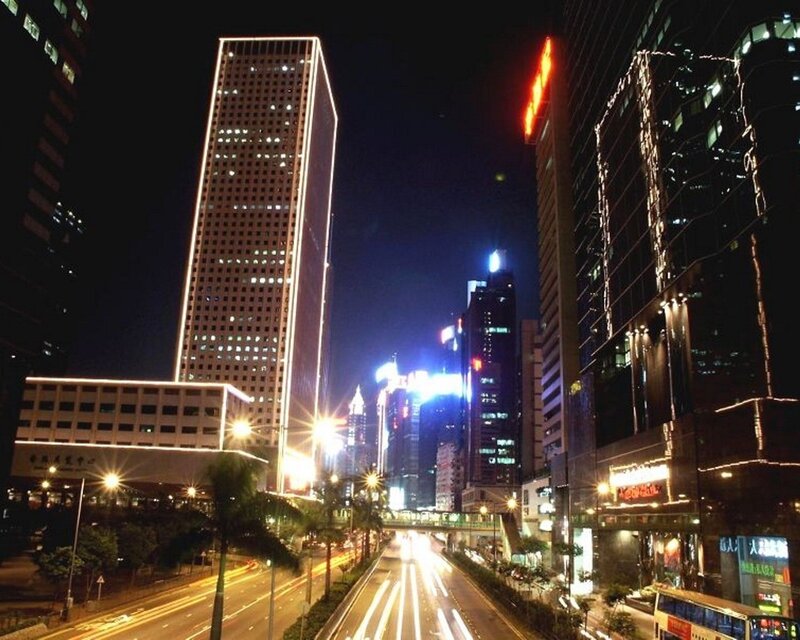 nighttime city street with skyscrapers