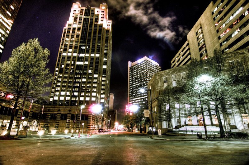 Nighttime city street with skyscrapers
