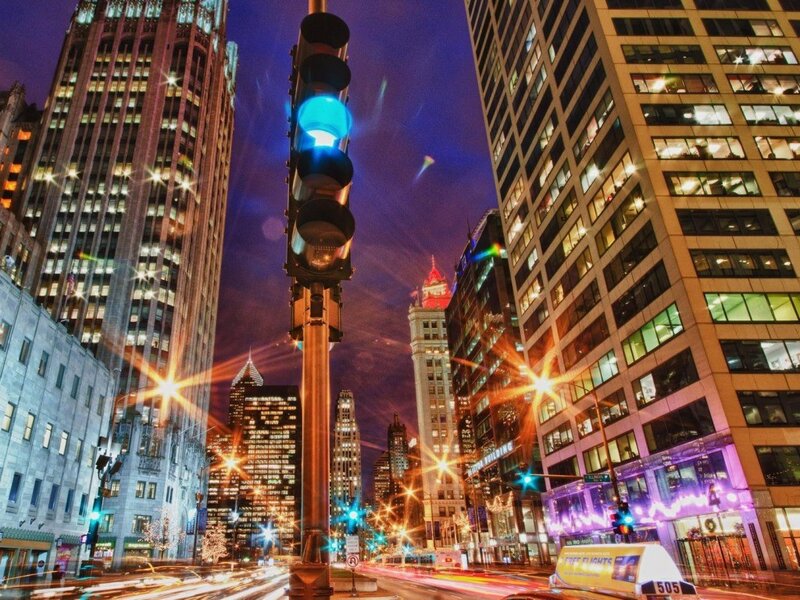 nighttime city street with traffic lights