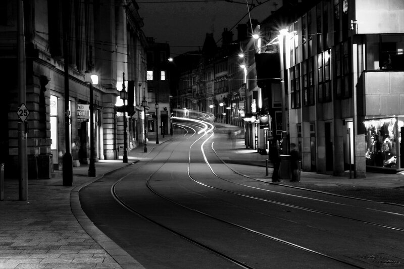 Nighttime city street with tram tracks
