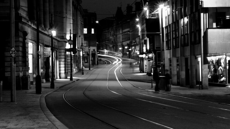 Nighttime city street with tram tracks