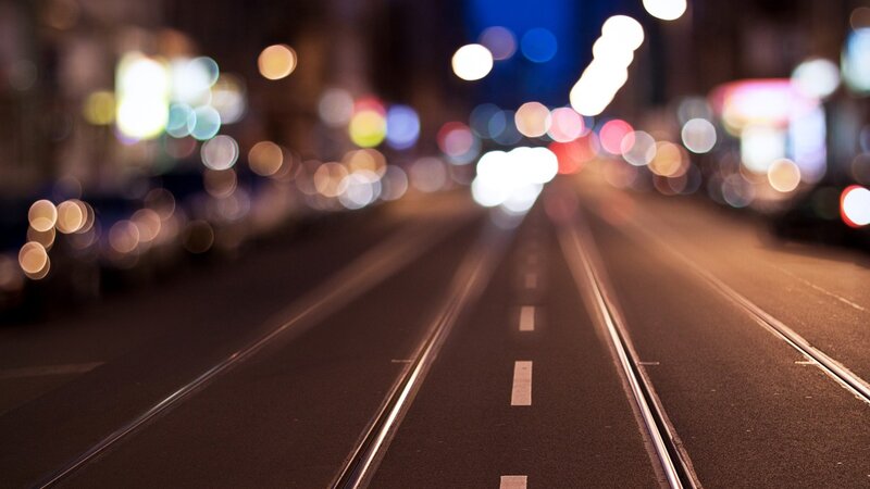 Nighttime city street with tram tracks