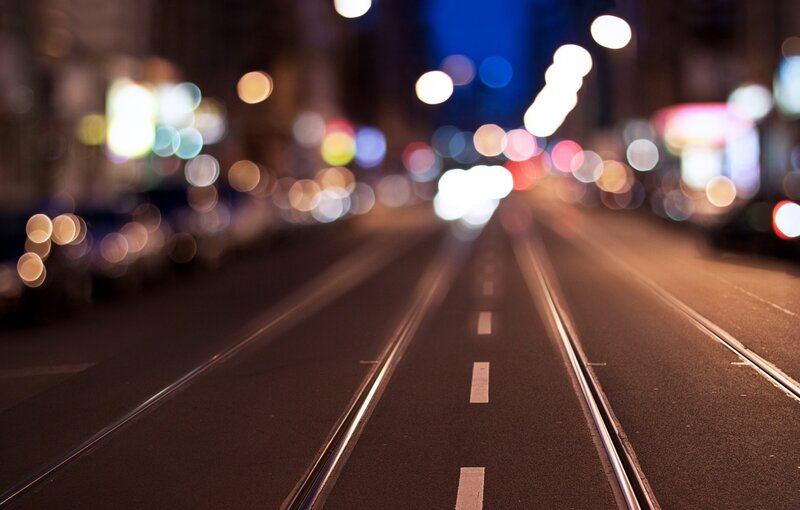 Nighttime city street with tram tracks