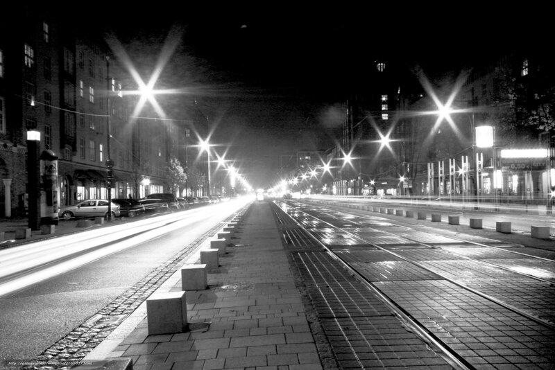 Nighttime city street with tram tracks