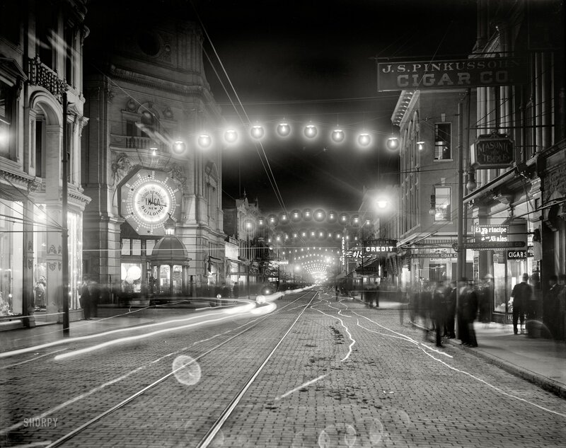 Nighttime city street with trolley tracks