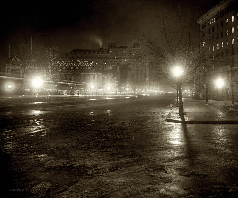 Nighttime city street with vintage ads
