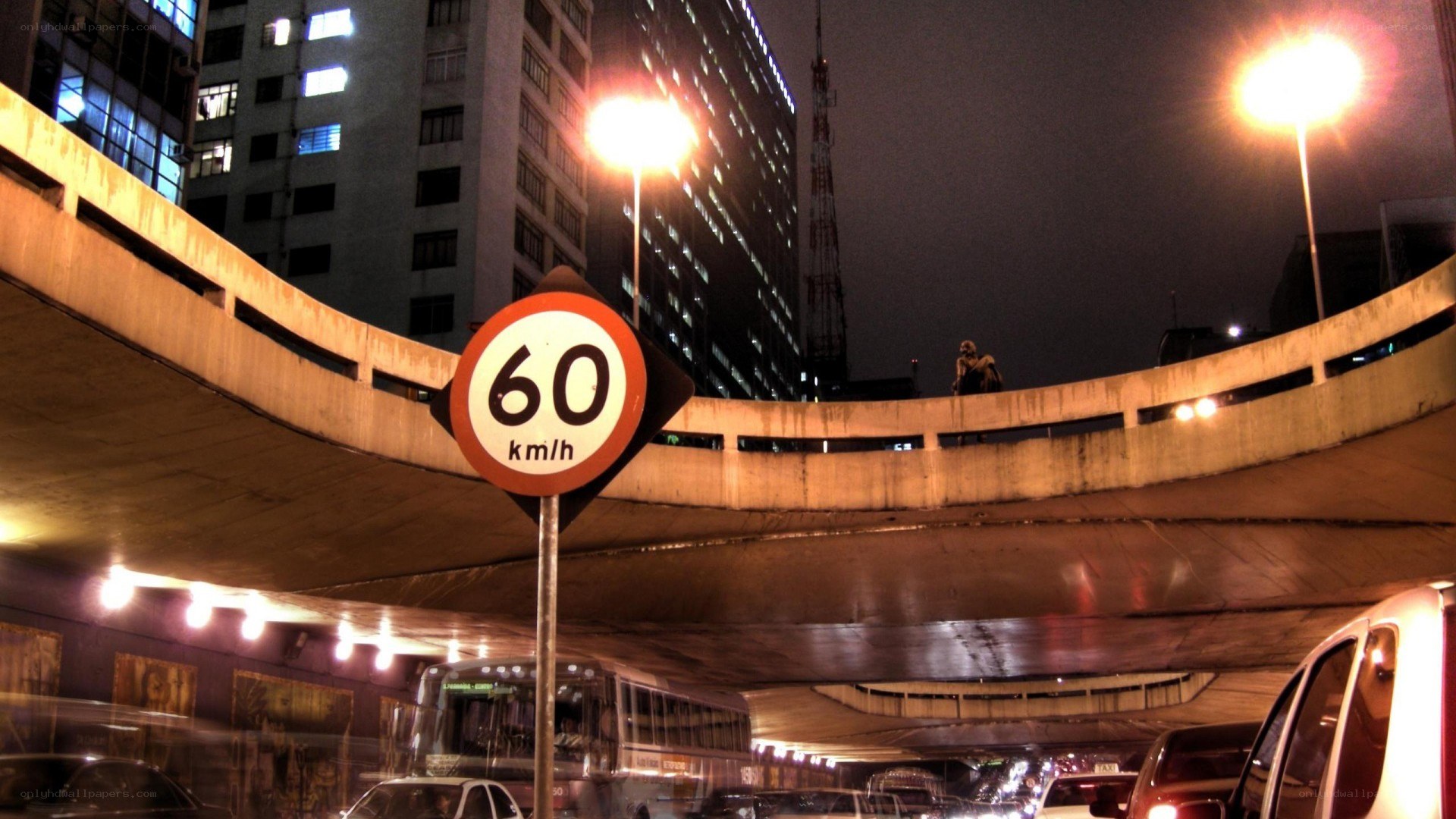 Nighttime city traffic under overpass