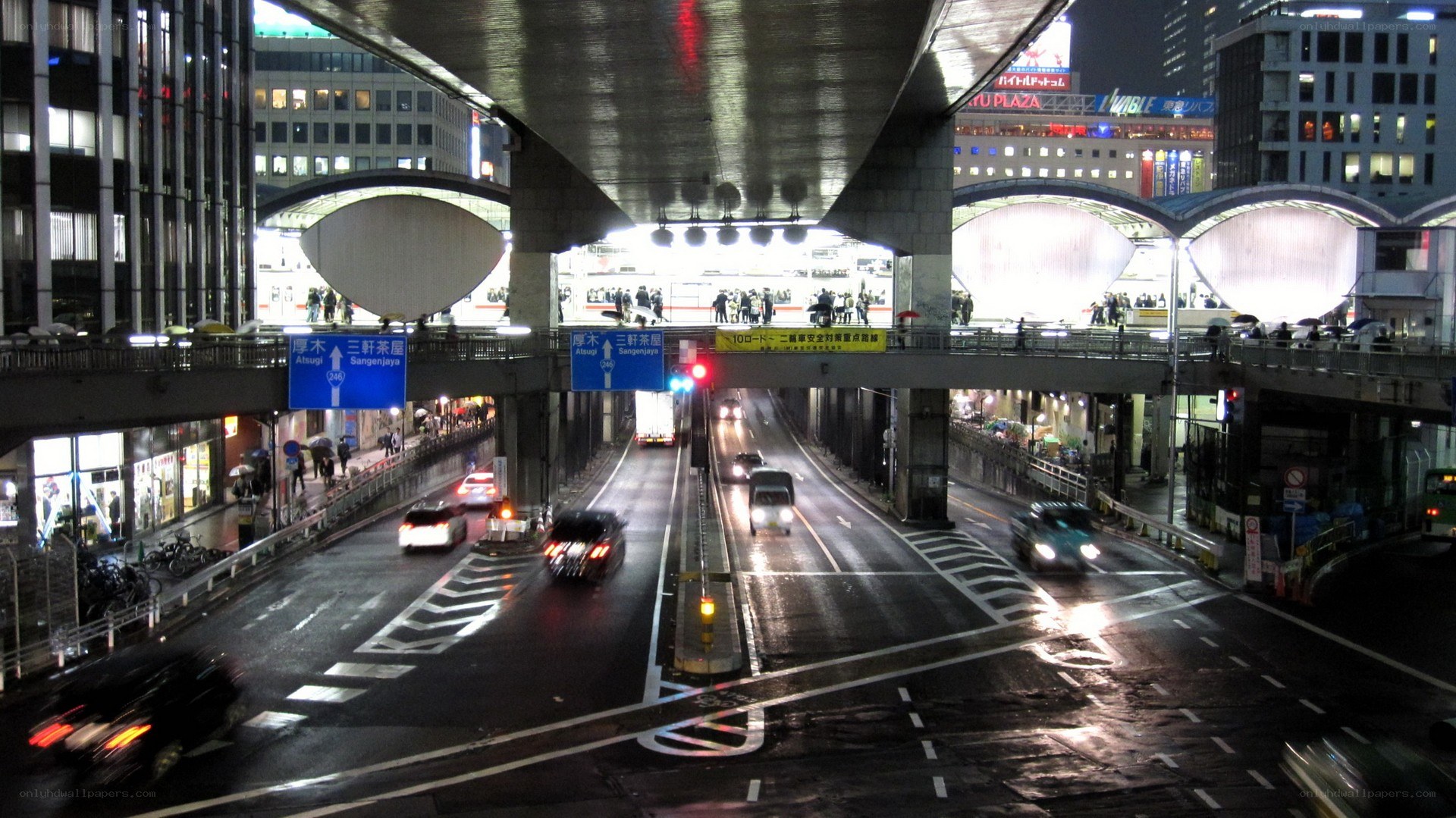 Nighttime city traffic under overpass