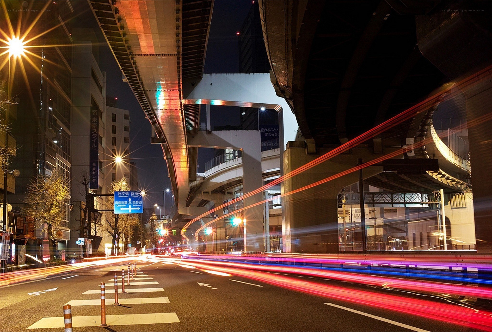 Nighttime city traffic under overpass