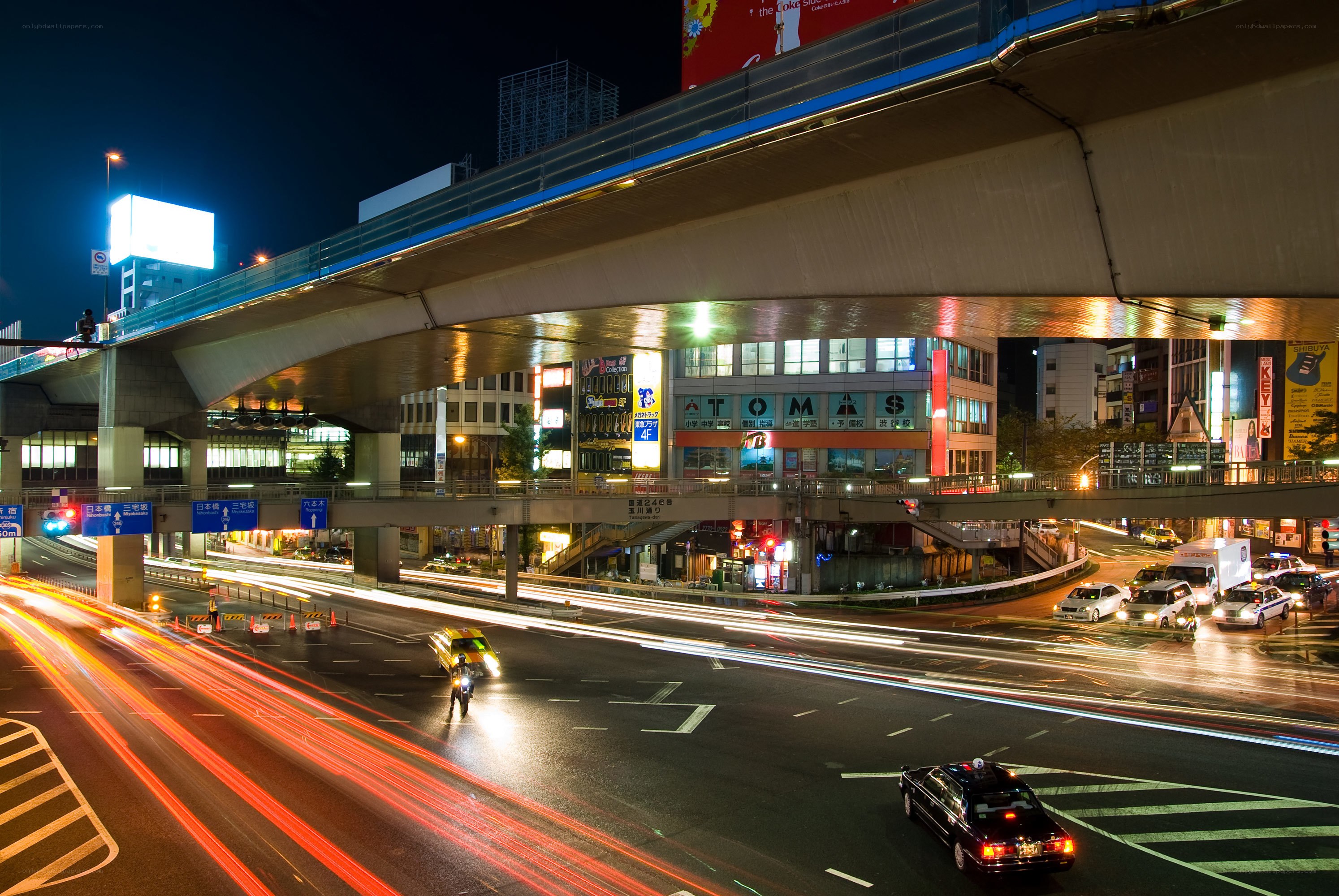 Nighttime city traffic under overpass