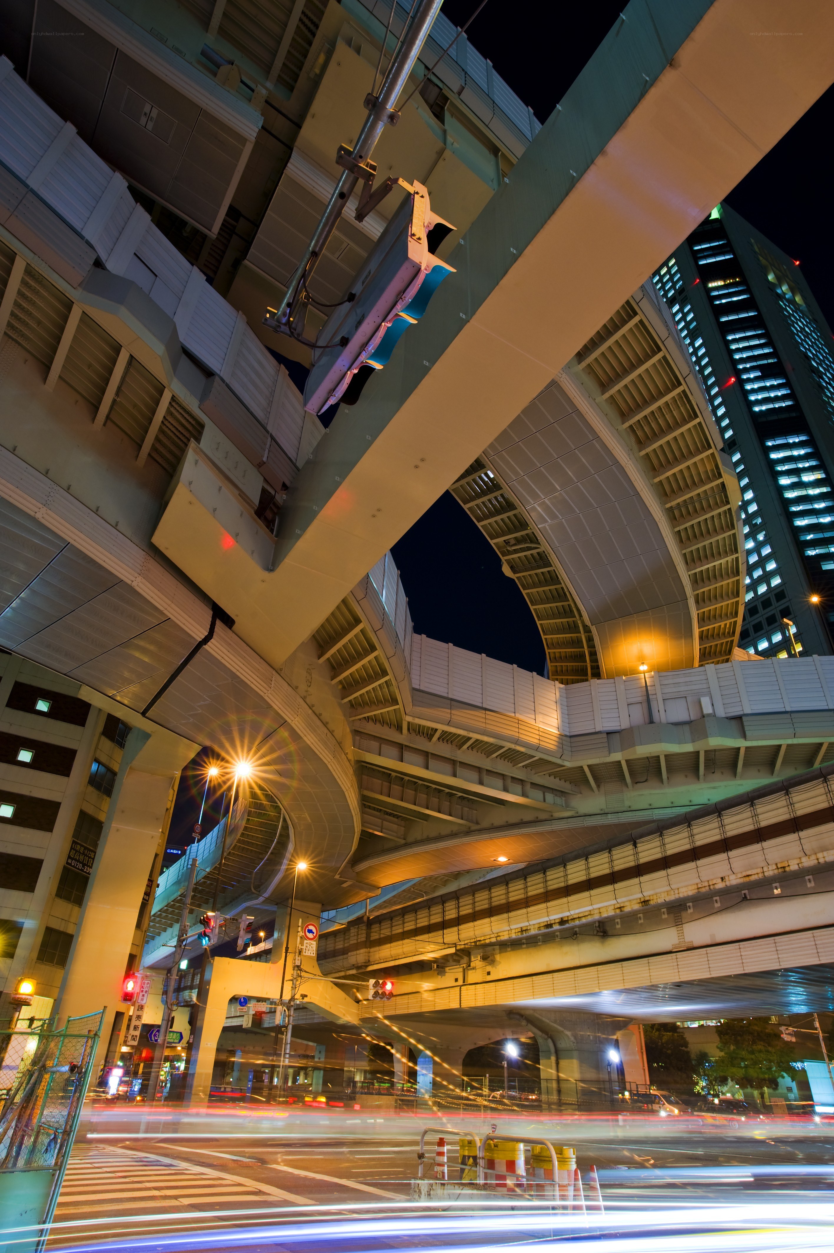 Nighttime city traffic under overpasses