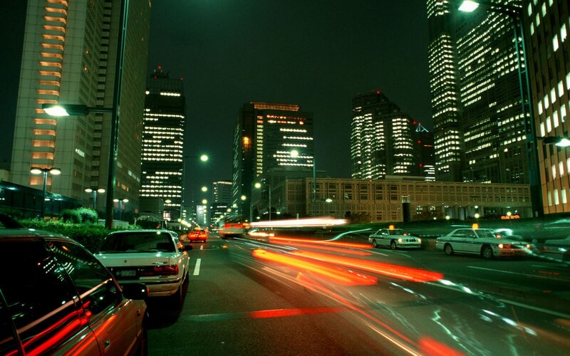 nighttime city traffic with light trails