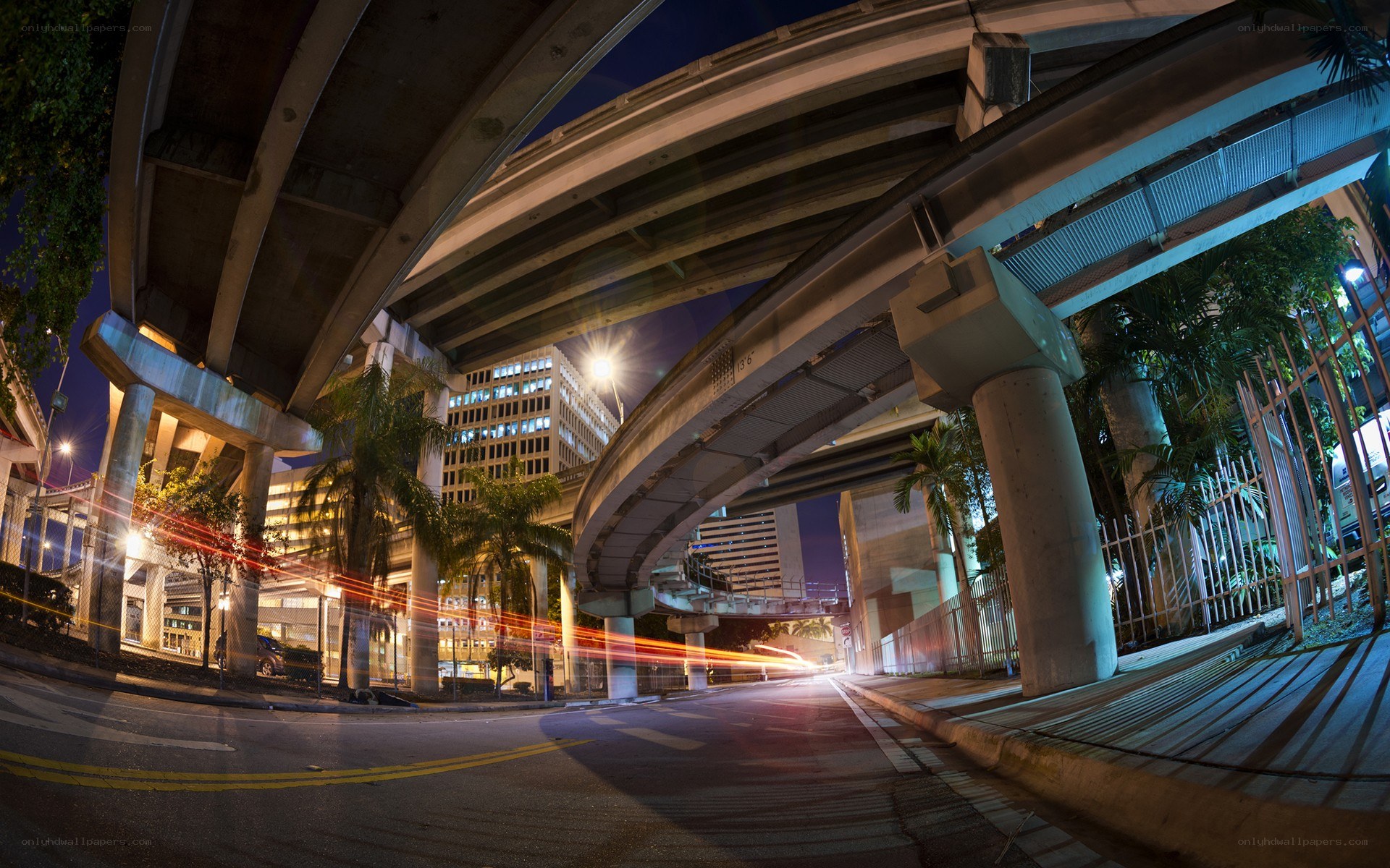 Nighttime city underpass with light trails