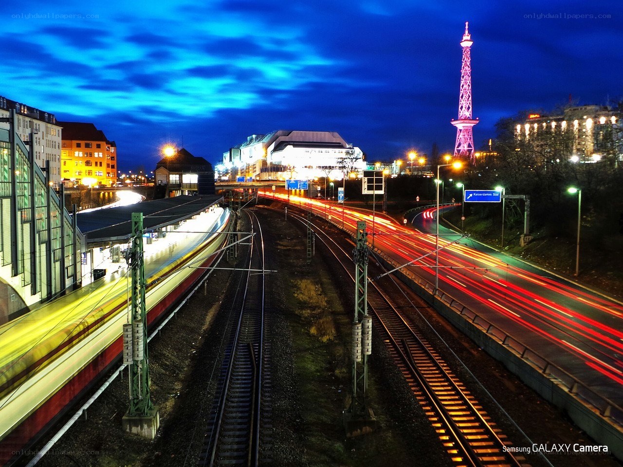 Nighttime city with train and tower