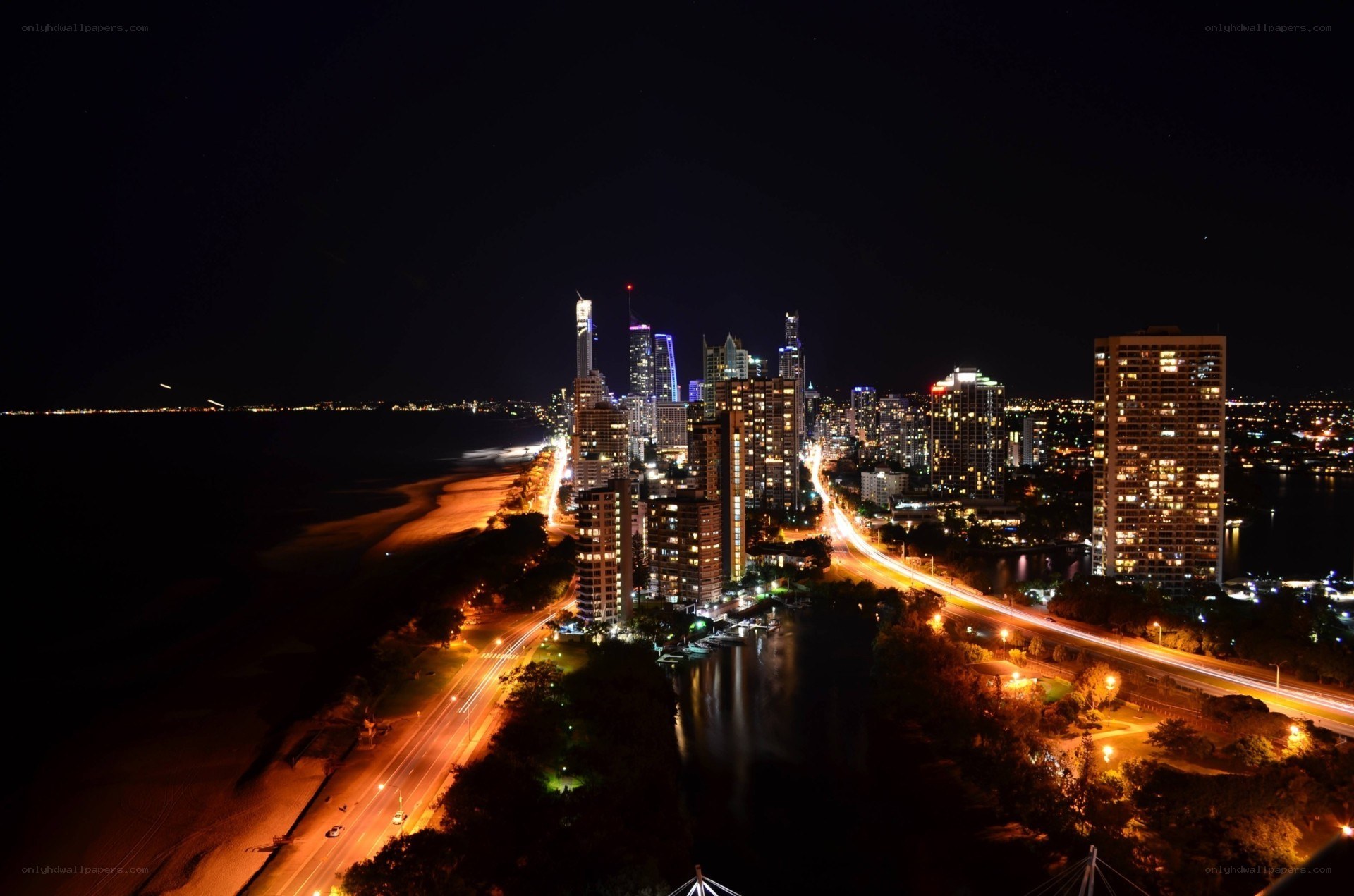 nighttime cityscape by the coast