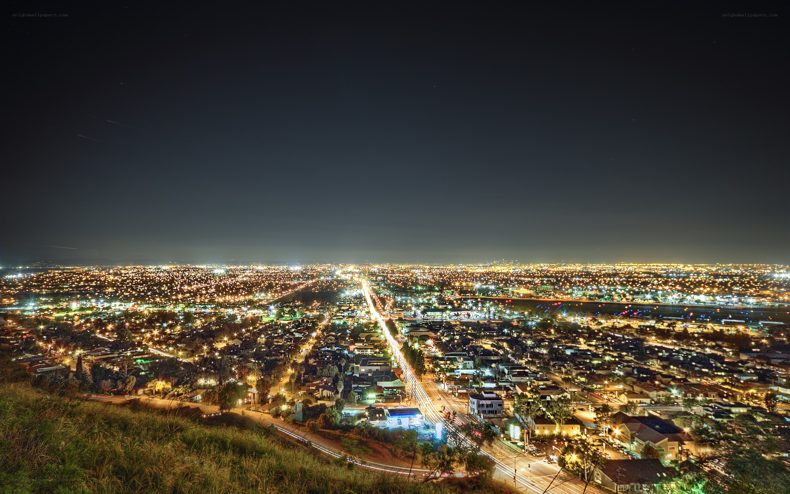 nighttime cityscape from hilltop