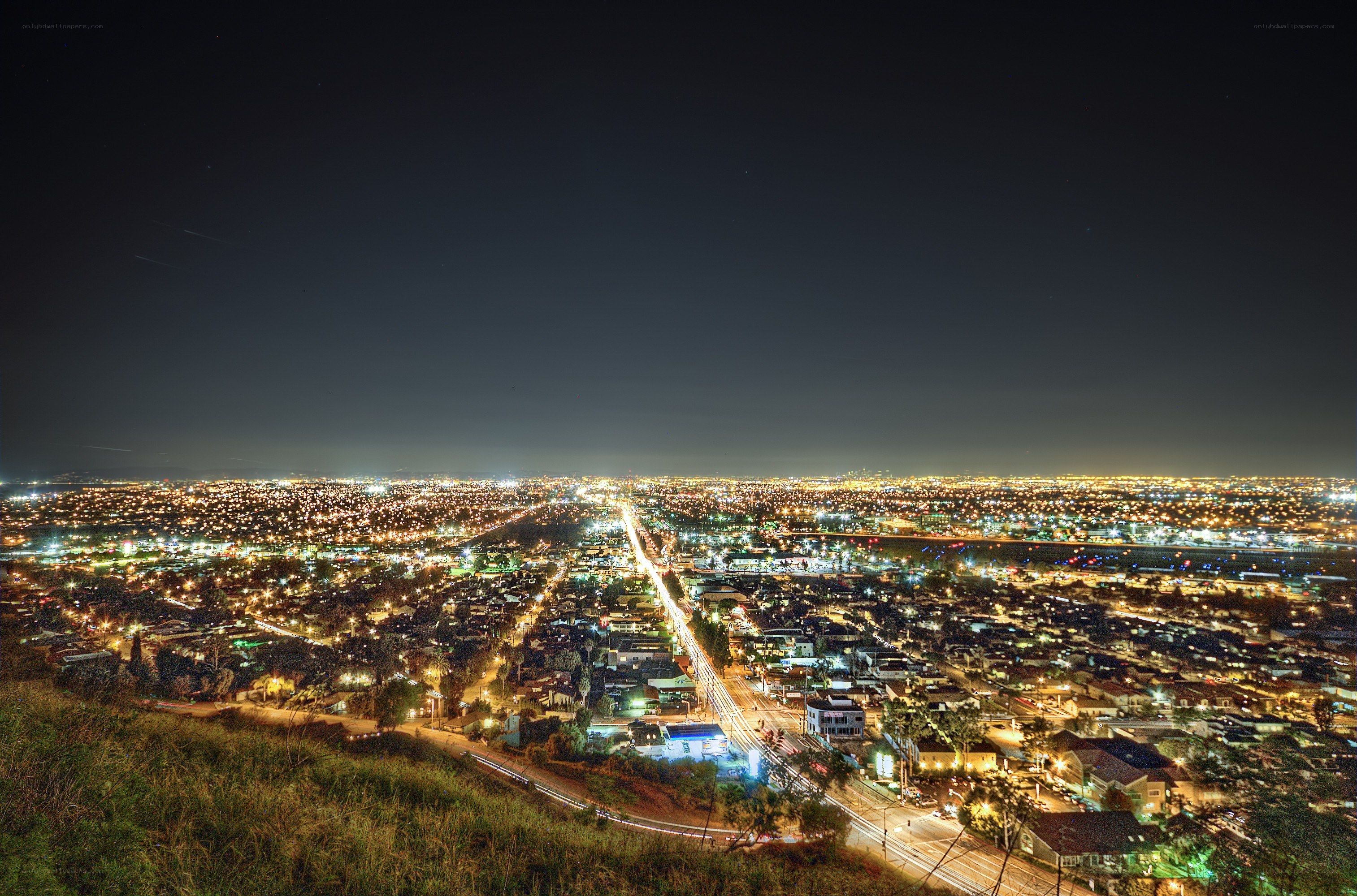 nighttime cityscape from hilltop
