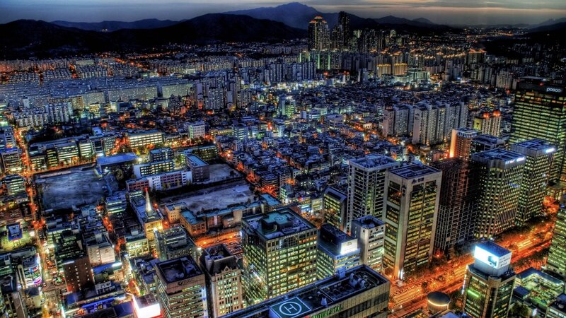 Nighttime Cityscape View — Blue, Dramatic, Night, Photograph, Buildings, Mountains, Streets, Yellow